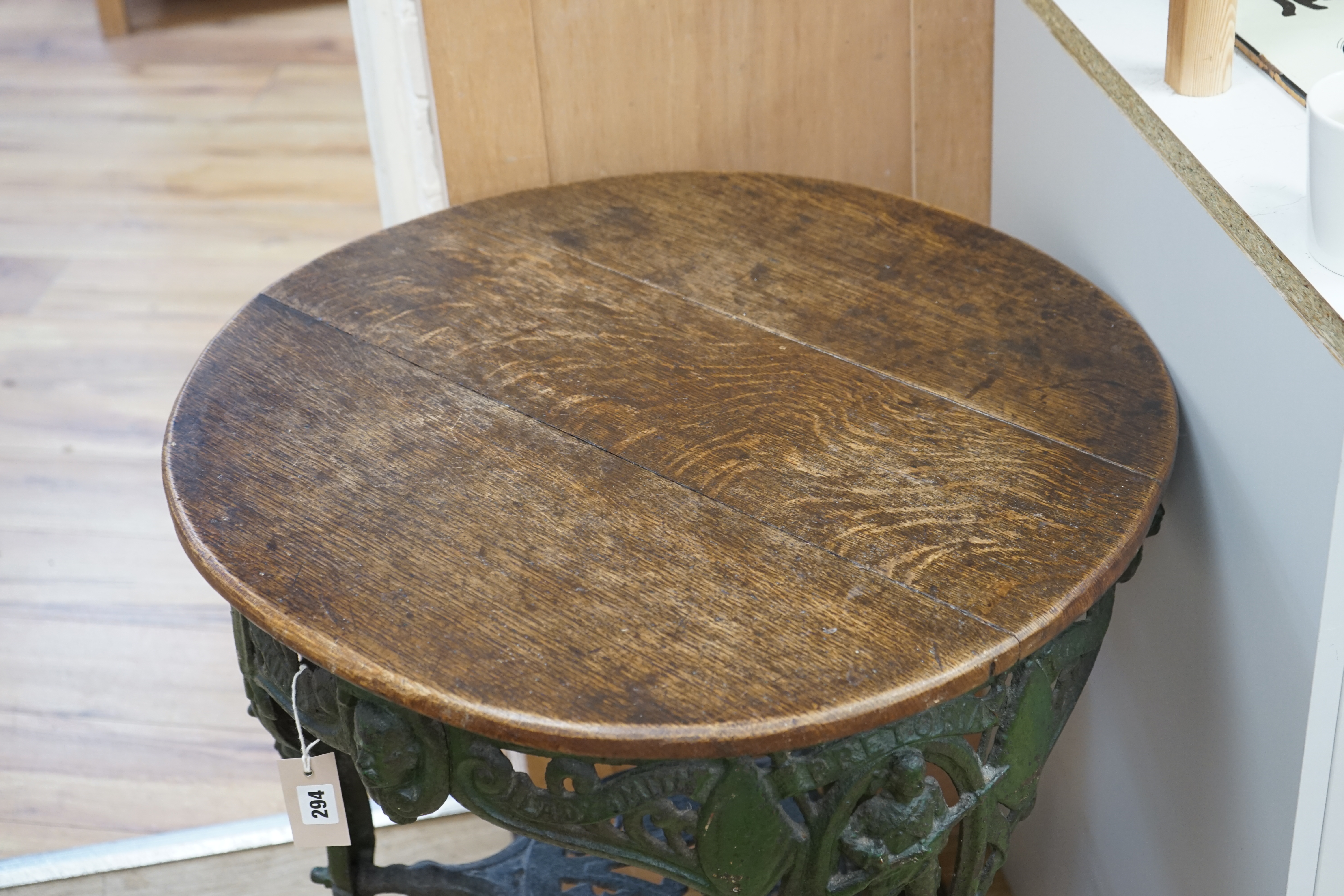 A rare early 20th century Boer War commemorative cast iron pub table, decorated with standing soldiers beneath Ladysmith, Pretoria and Mafeking scrolls, legs bearing registered number 364112, the circular oak top 62cm di